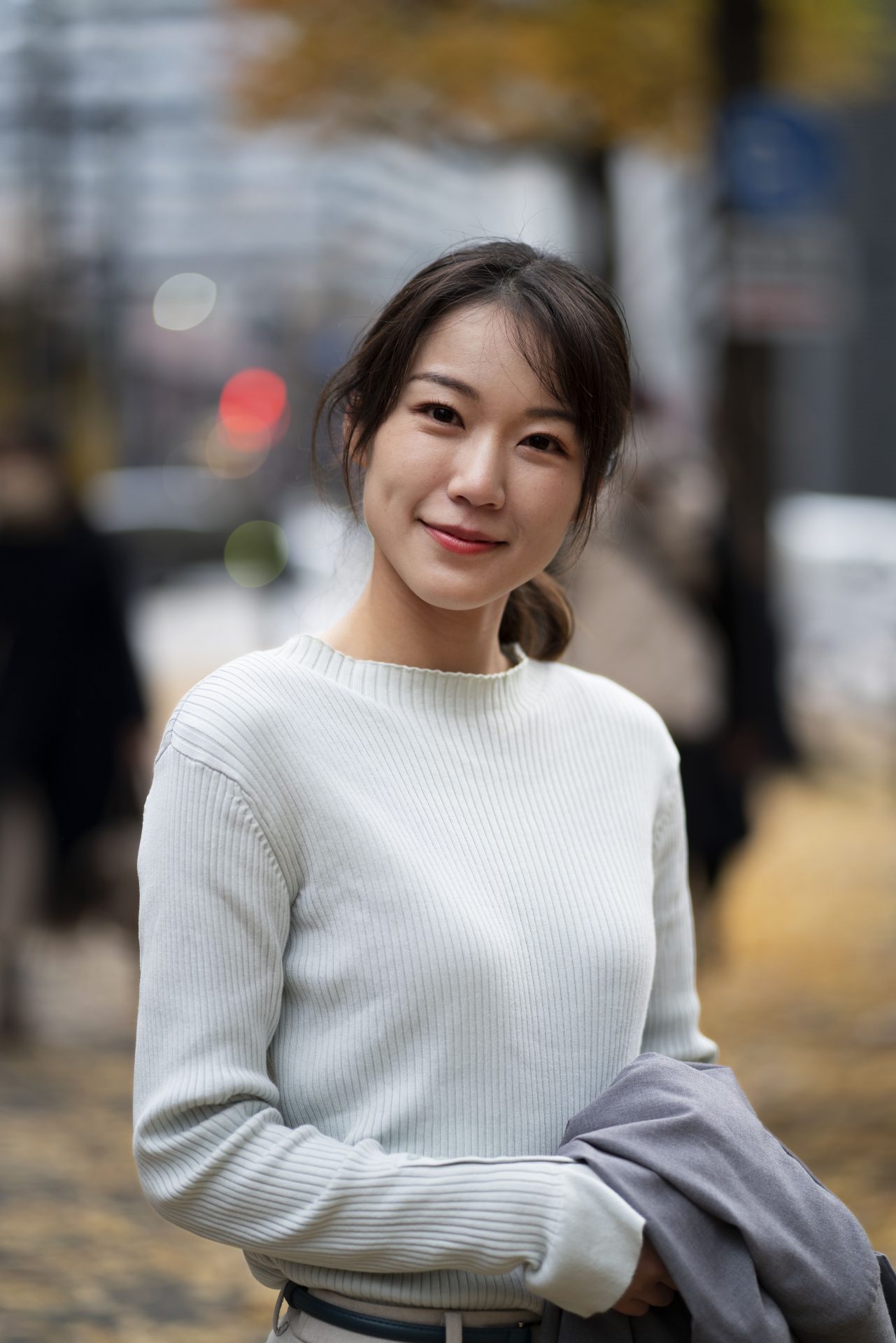 Asian woman looking at camera outside
