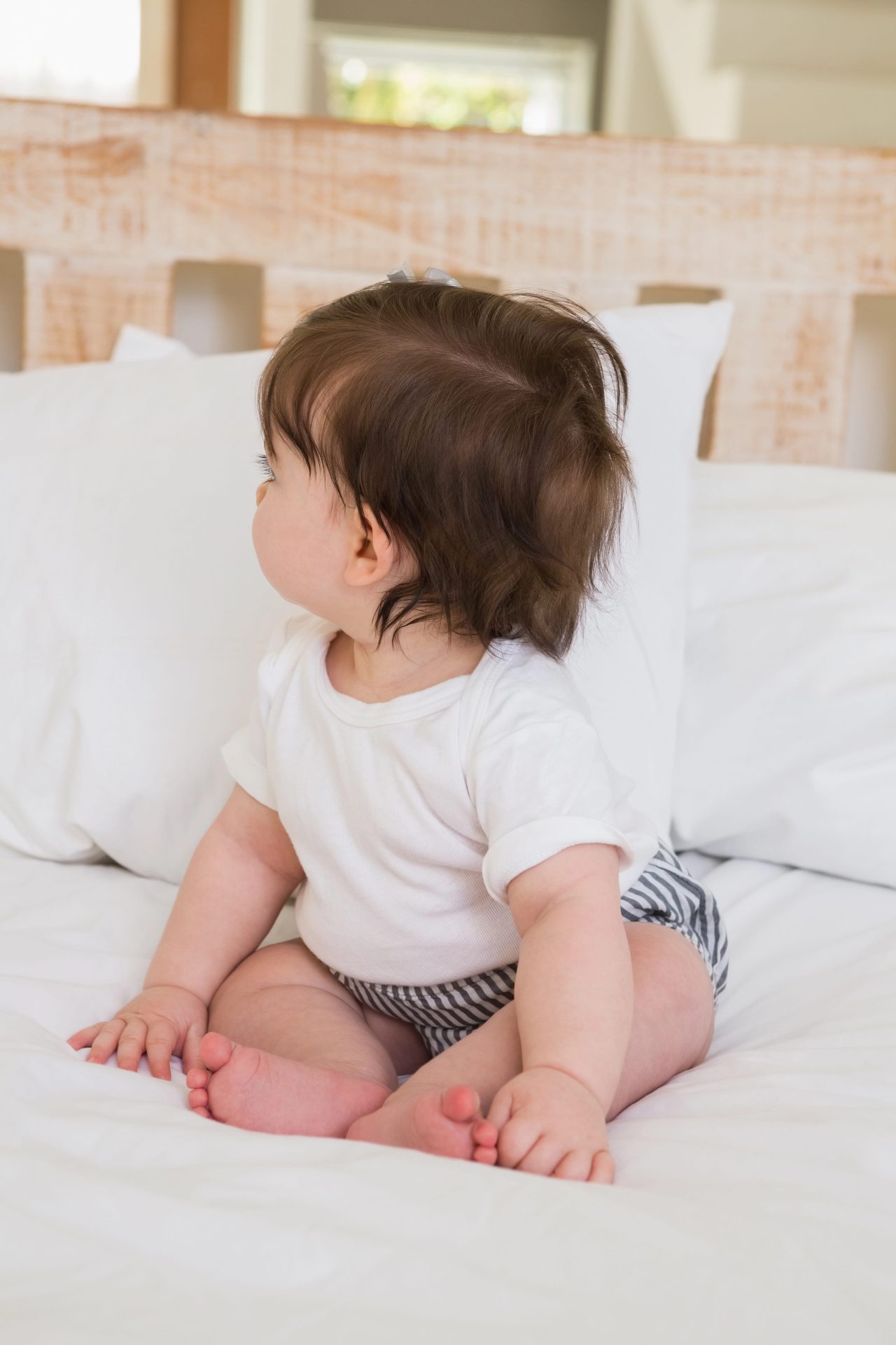 Depositphotos_76629483_XL-min Infant resting comfortably on a bed