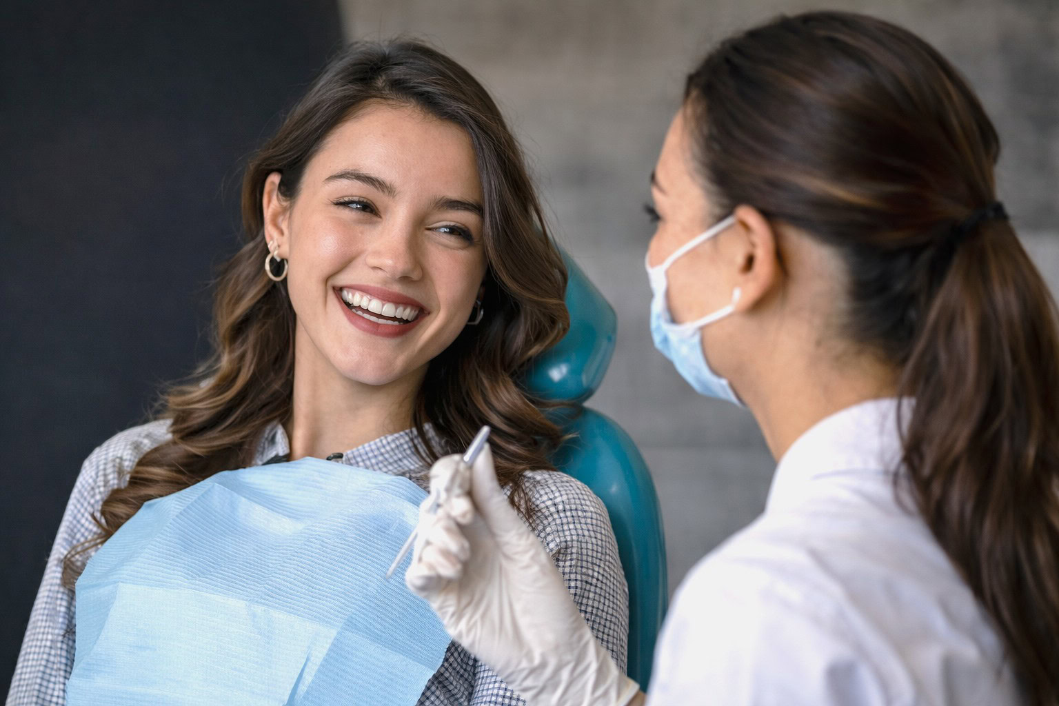 Beautiful-positive-young-woman-smiling in exam chair