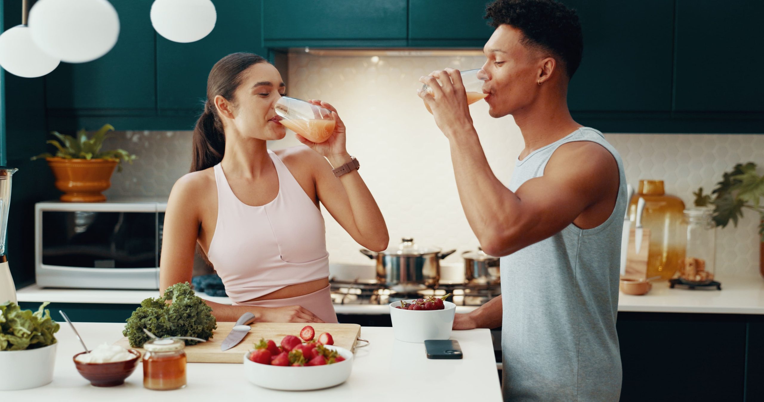 Couple drinking juice breakfast house healthy meal nutrition diet bonding together fitness people vegan drink gut health morning detox weight loss with ingredients.