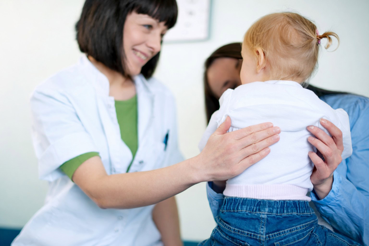 Doctor examining little girl.