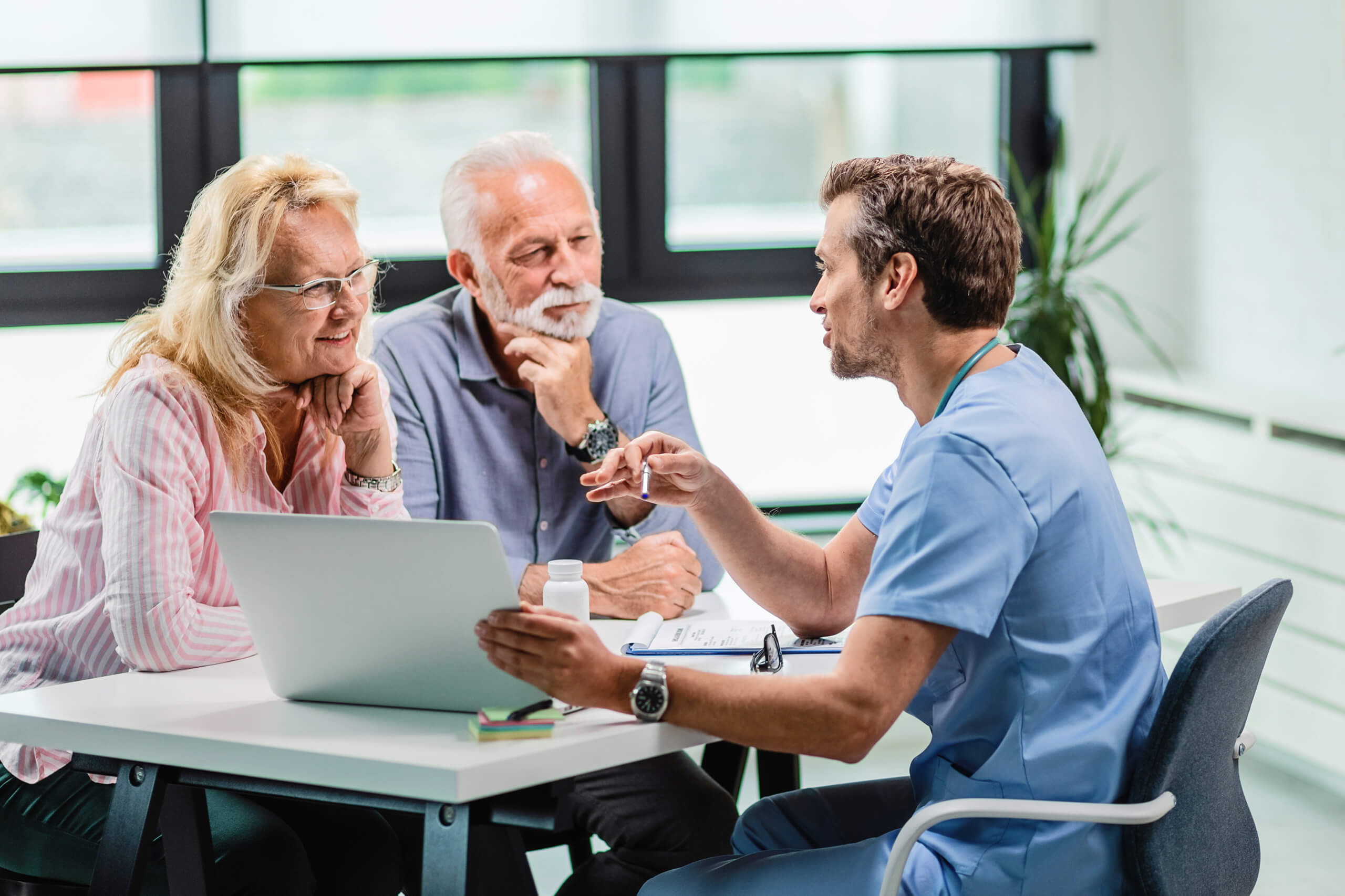Doctor explaining treatment to parents in the office.
