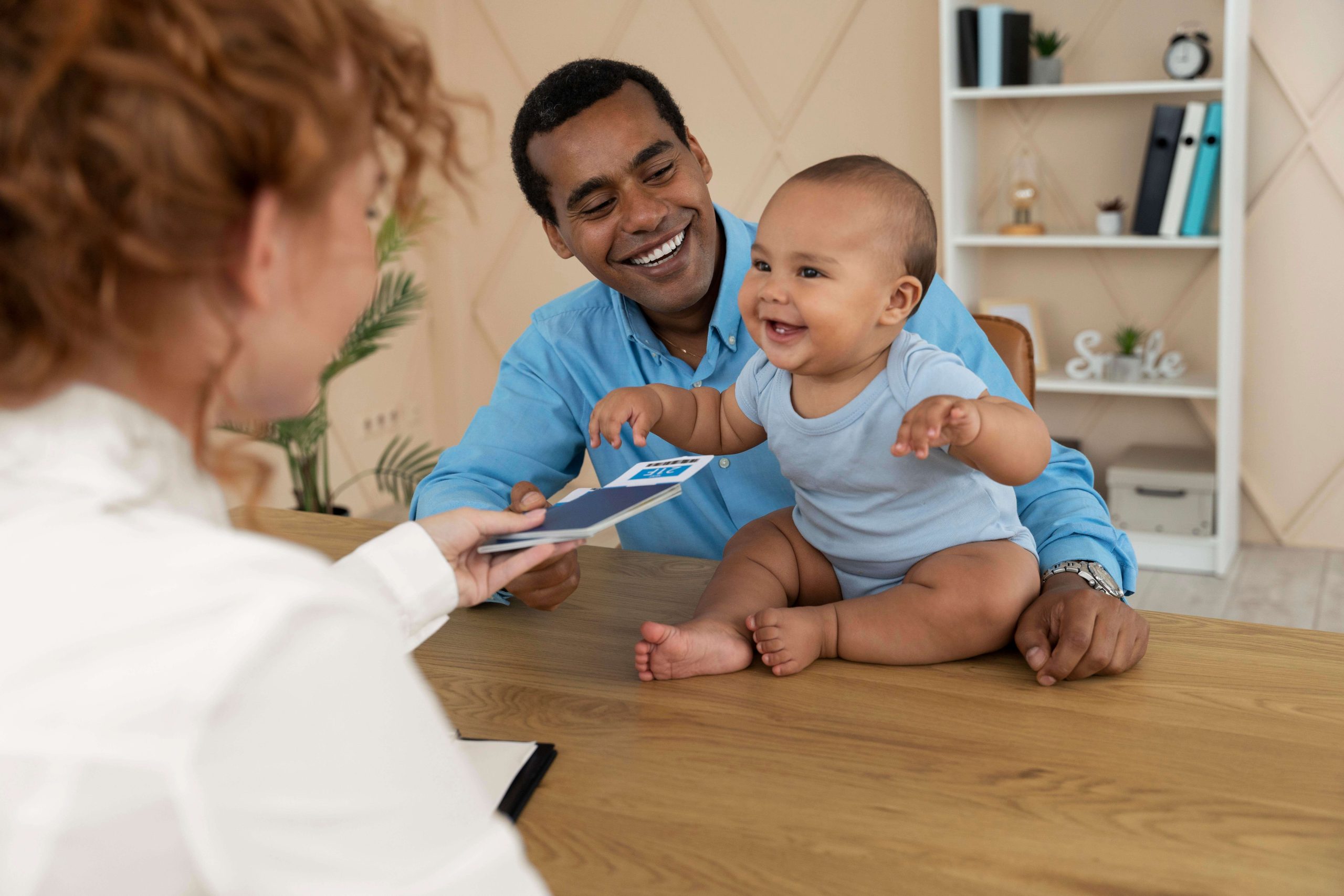 father with baby in pediatrician office