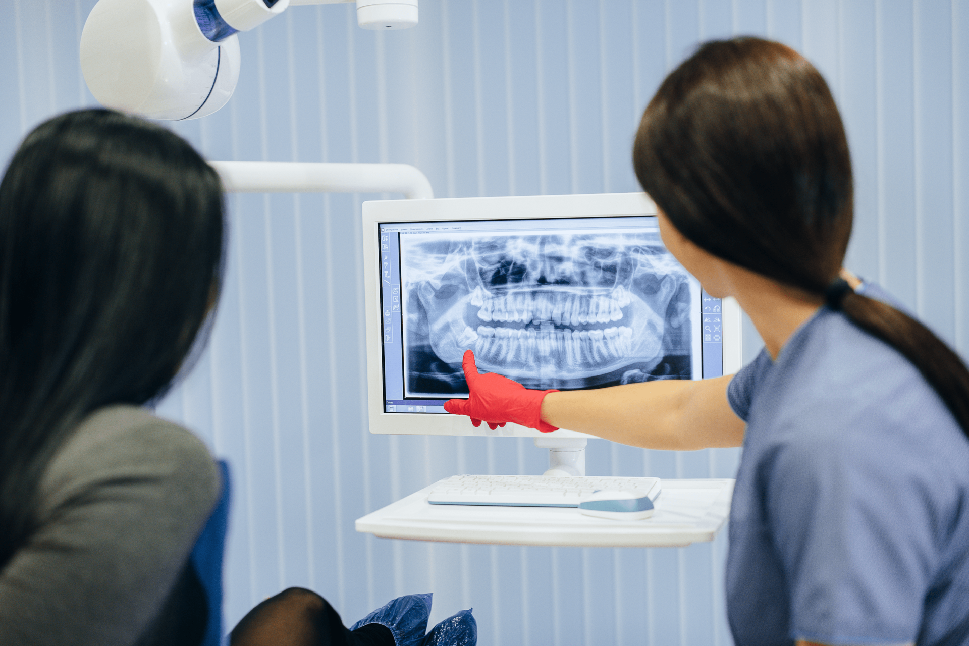 Dentist shows picture patient s teeth tells necessary treatment dentistry health.