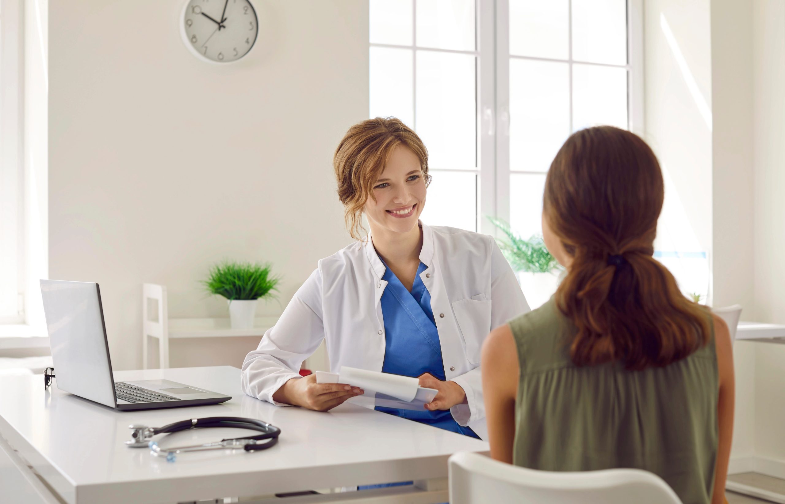 Doctor discusses a care plan with a patient during an in-person consultation designed to streamline pre-surgical visits.