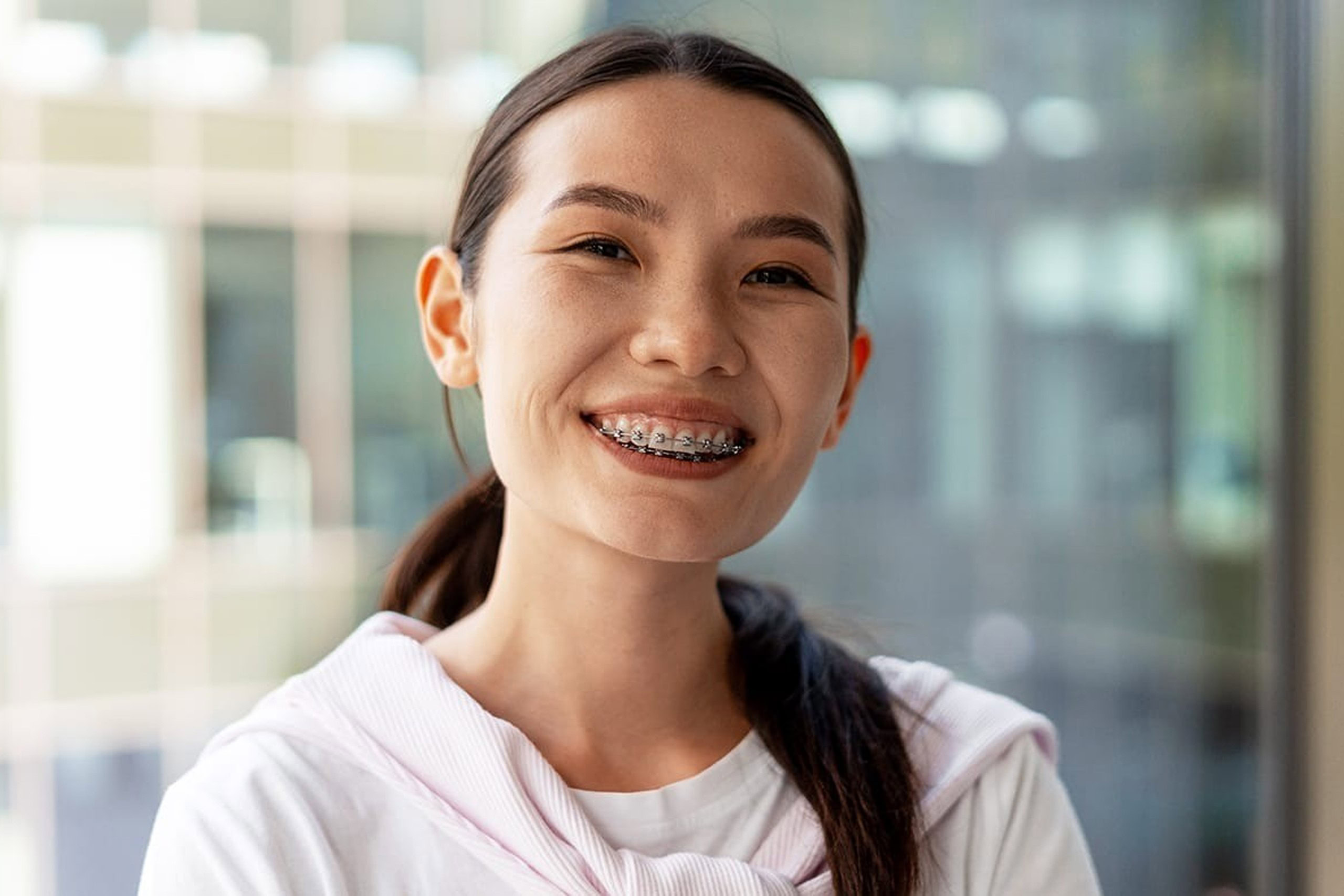 Female wearing braces.