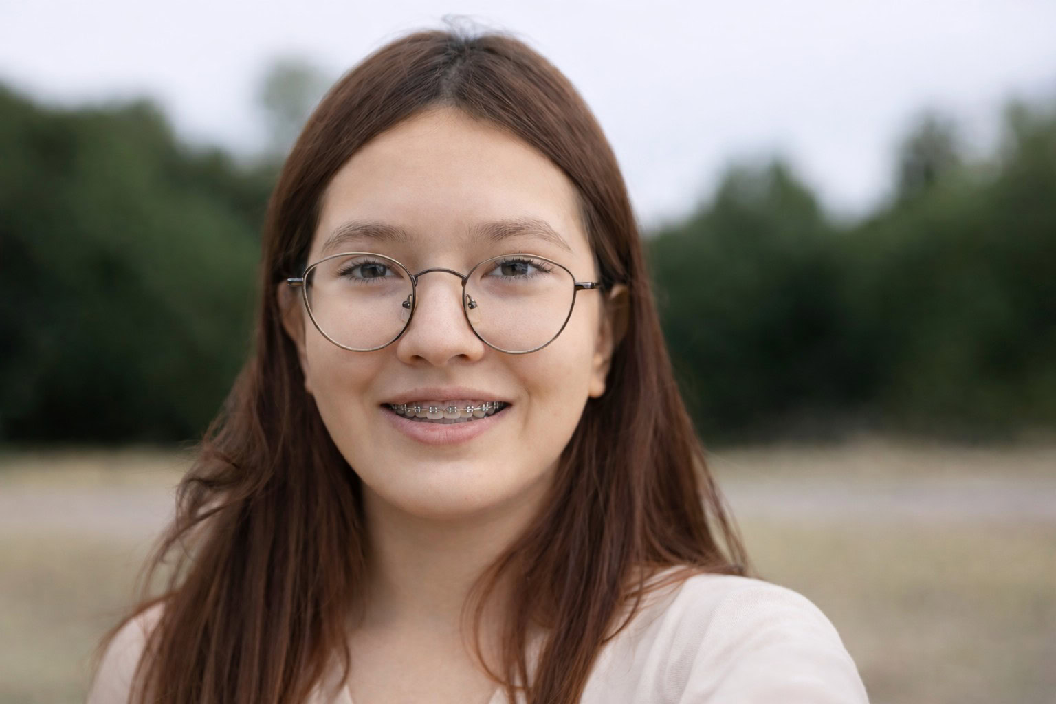 Girl wearing braces eyeglasses.