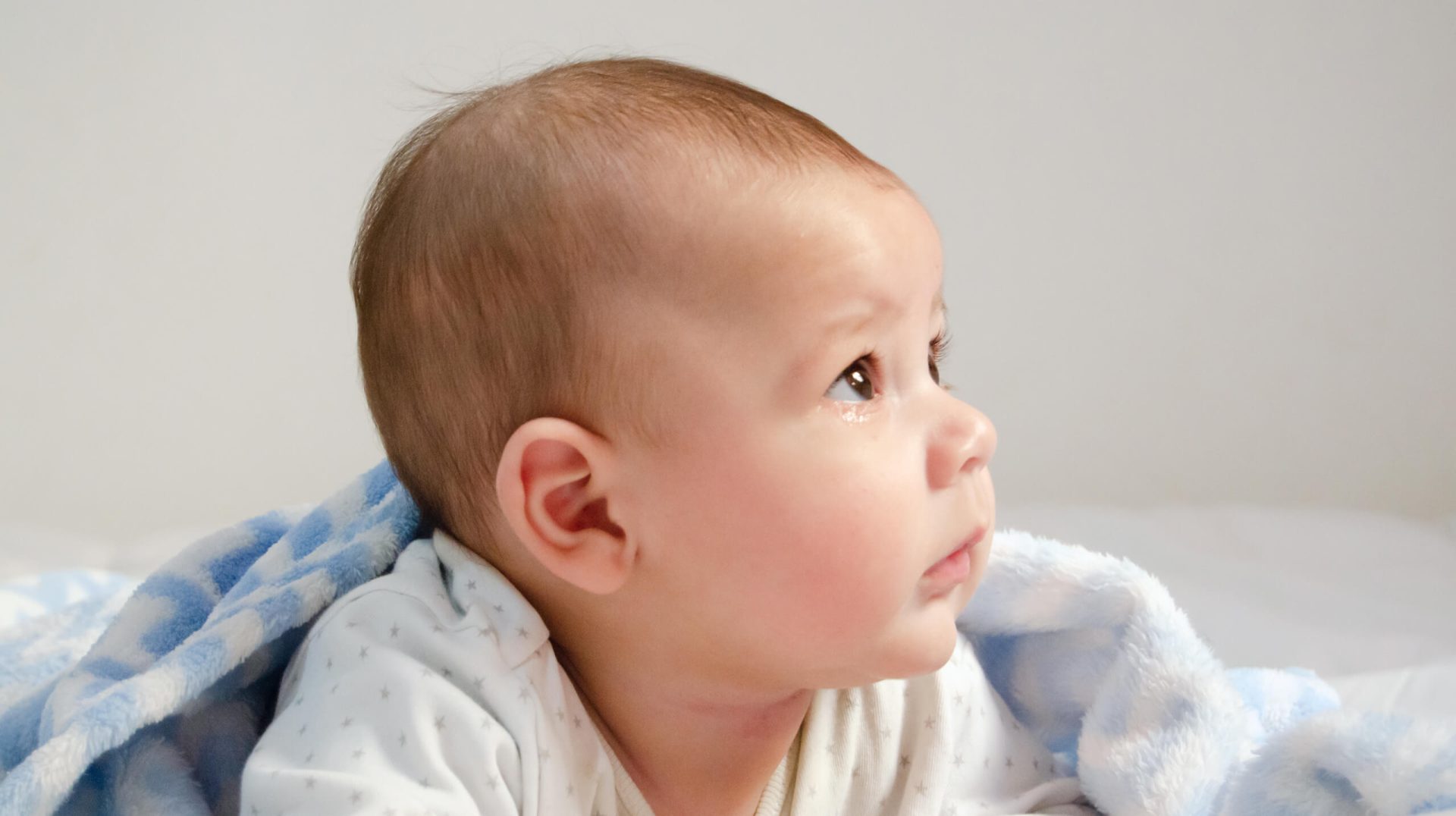 Infant with blanket looking up