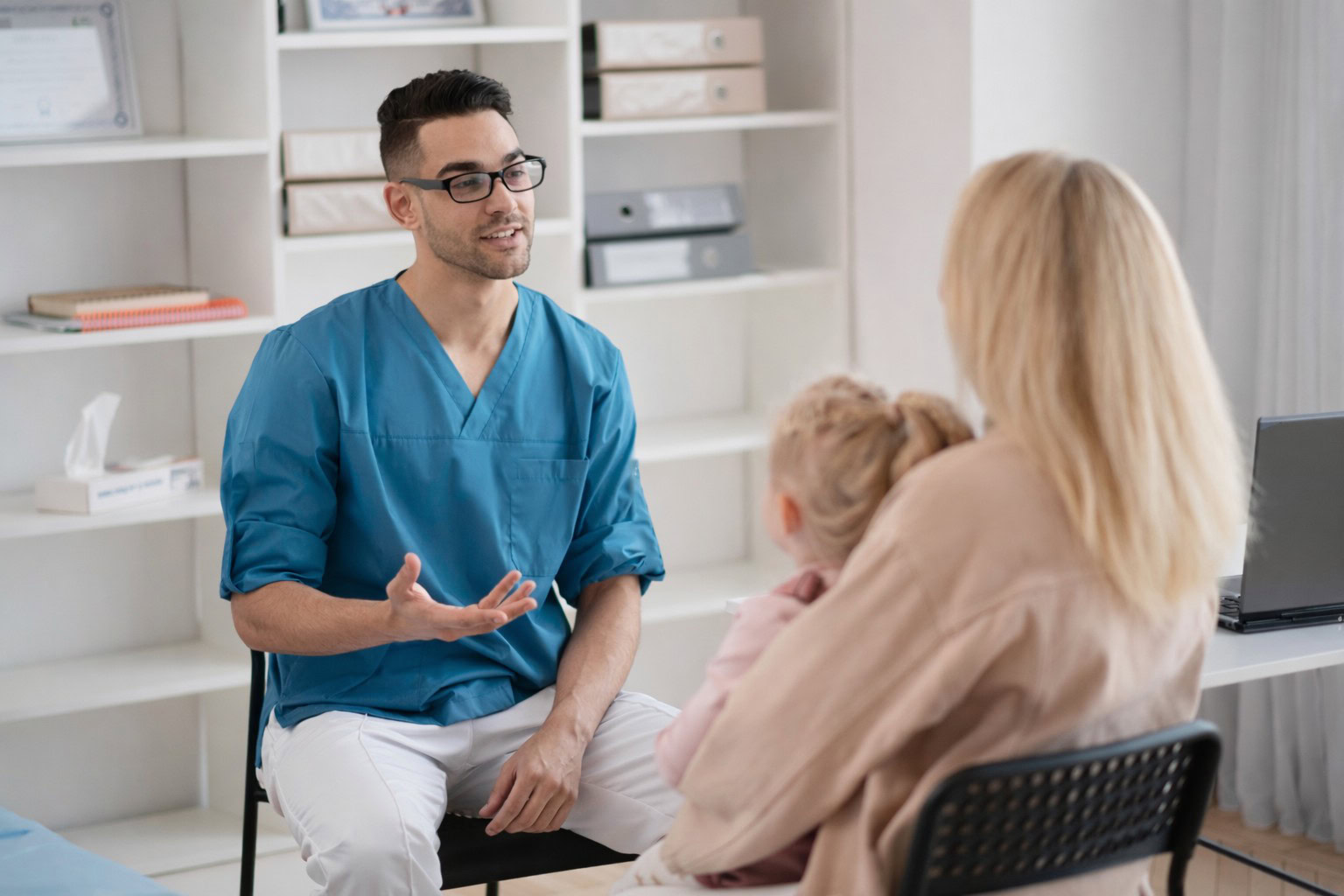 Doctor discussing health concerns with a mother and child in a clinic.