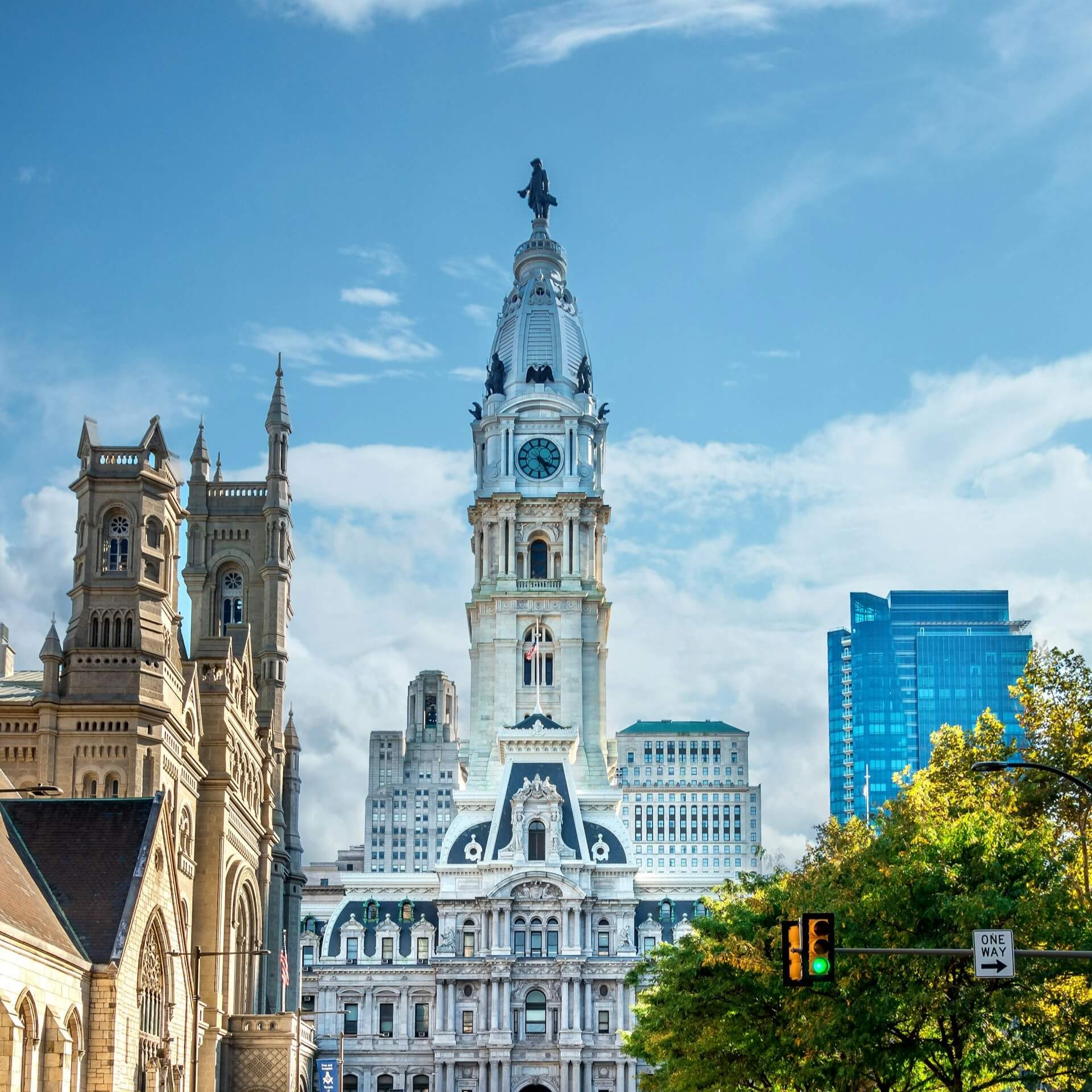 Philadelphia City Hall with Statue on top and surrounding historic buildings.
