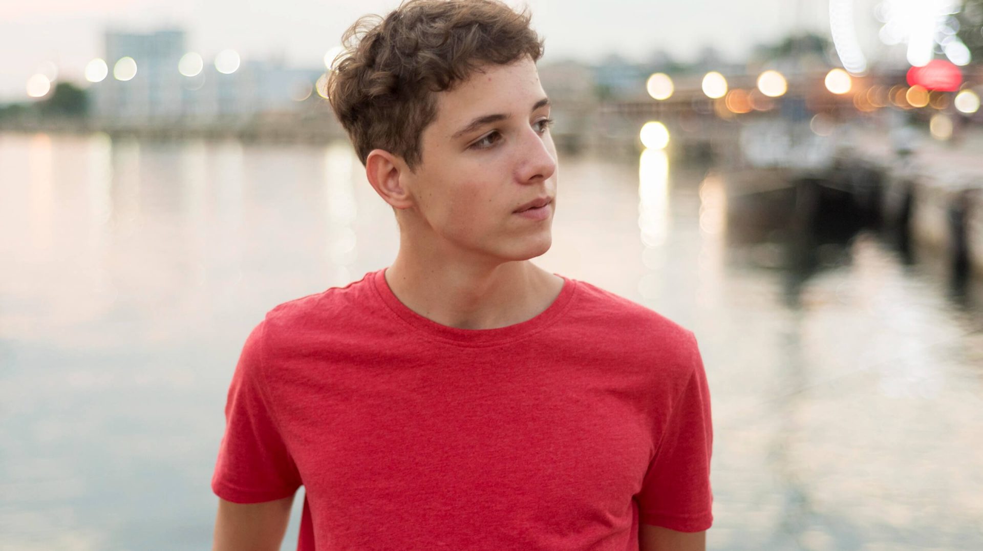 Portrait smiling teenage boy at beach
