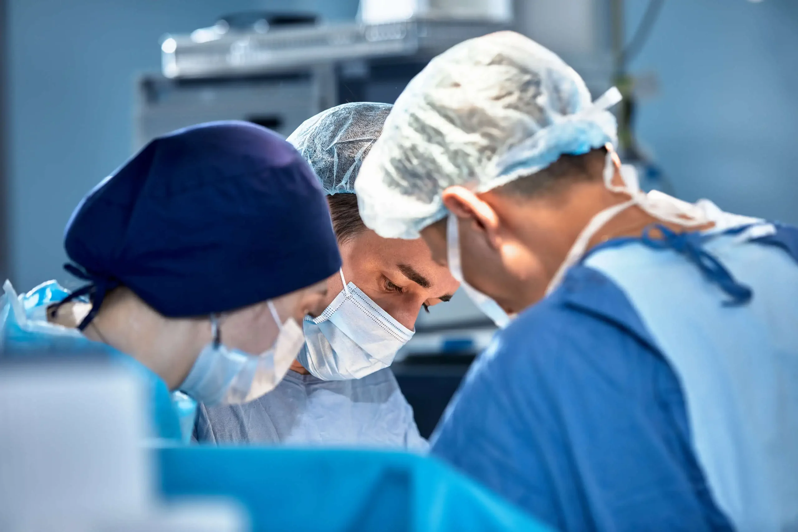 Surgeons Performing Facial surgery in operating room.
