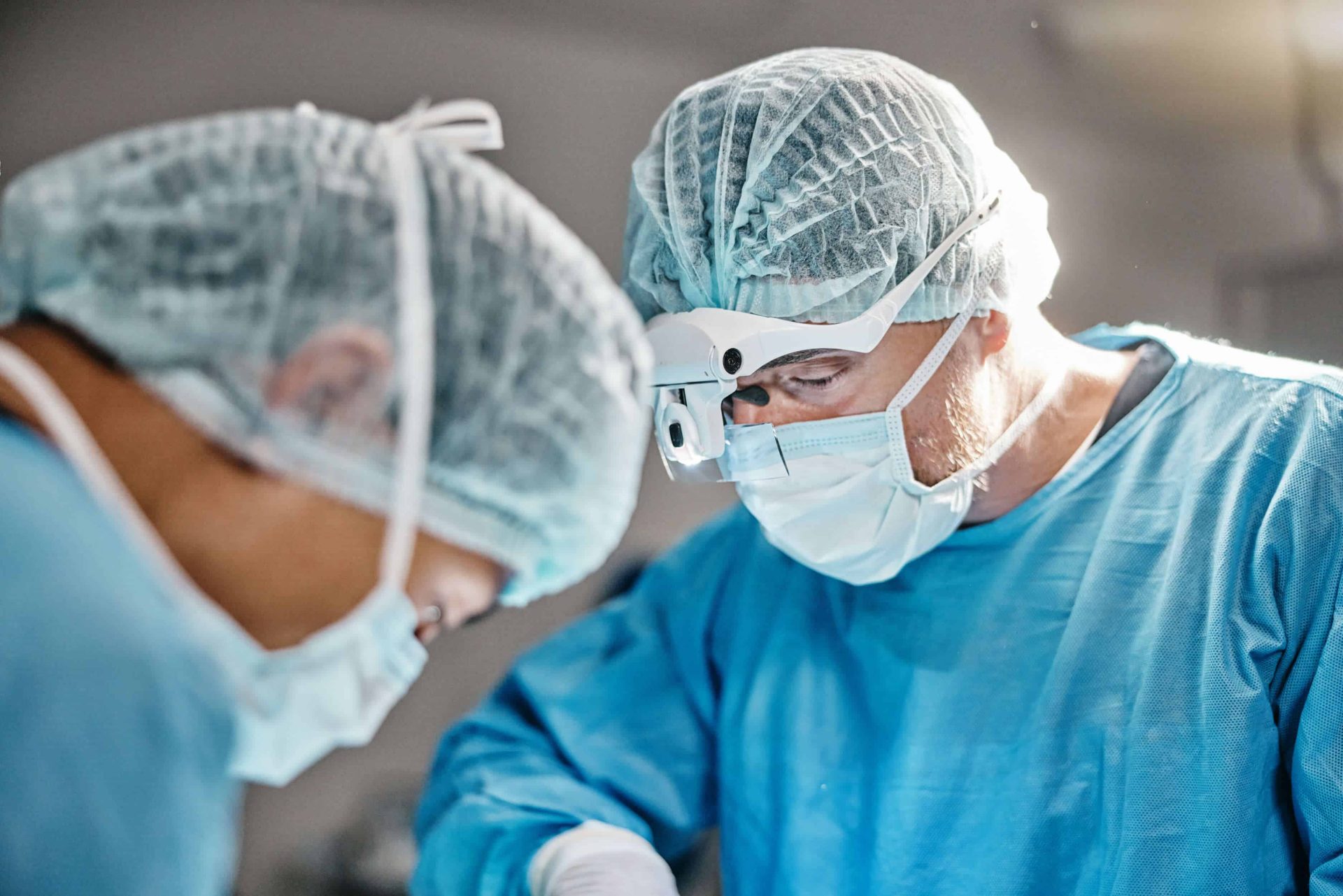 Two surgeons performing facial reconstructive surgery in the operating room