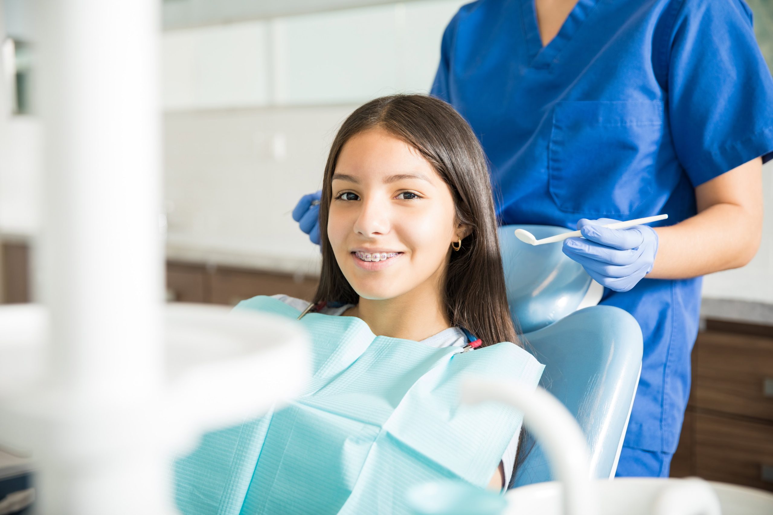 Young girl in examination chair in doctor's office