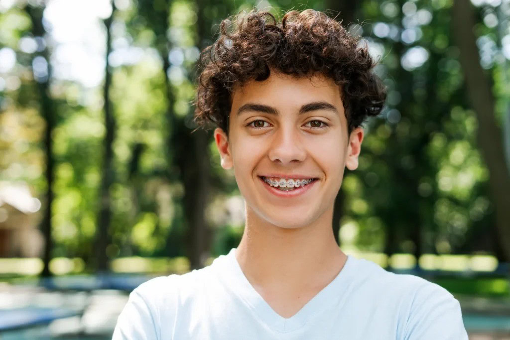 Young male wearing braces.